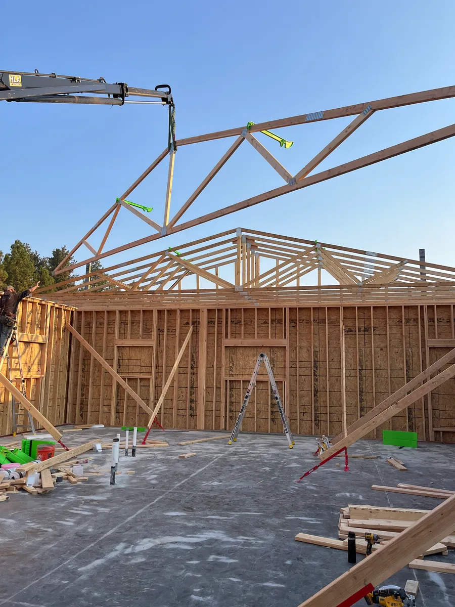 Walls framed with trusses being set